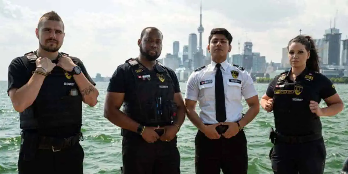 A group of mobile security guards standing next to a body of water.
