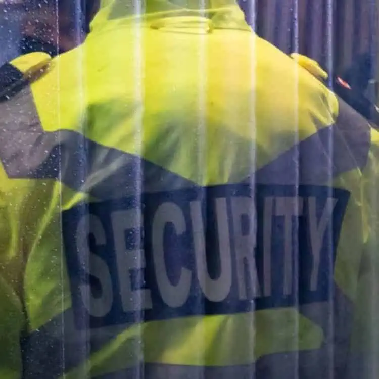A person in a yellow jacket conducting private investigations.