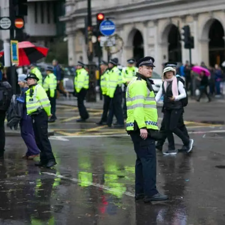 A group of police officers engaged in security training on a street in London.