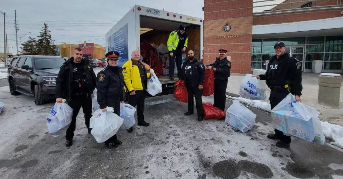 Uniformed security guard personnel from Ultimate Security Services in Toronto participating in a community donation event.