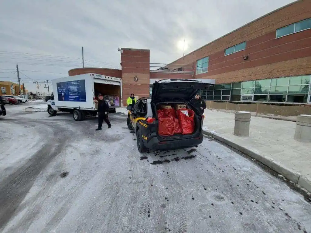 A Toy Mountain truck is parked in the parking lot of a hospital.