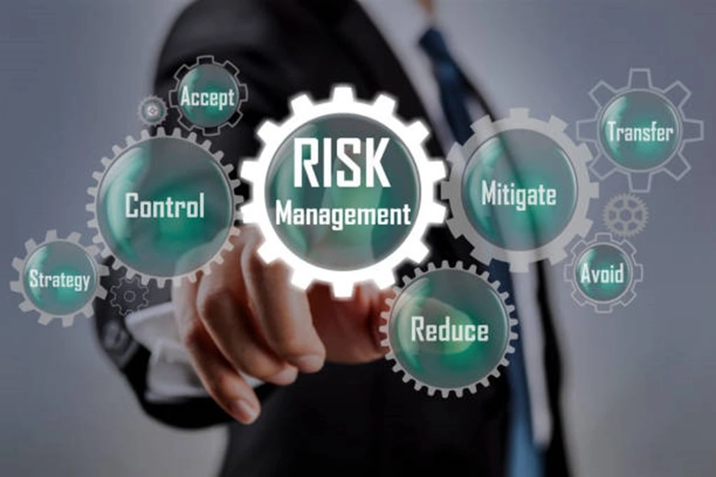 A person in a suit points to a gear labeled "Risk Management" surrounded by other gears labeled Strategy, Control, Accept, Reduce, Mitigate, Avoid, and Transfer. This intricate mechanism reflects the importance of proactive intelligence in effective threat assessment.