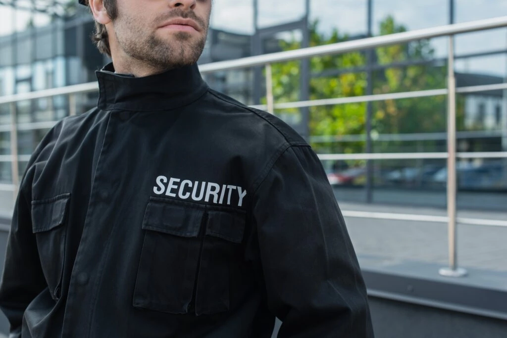 partial view of guard in black uniform with securi 2023 11 27 05 35 15 utc